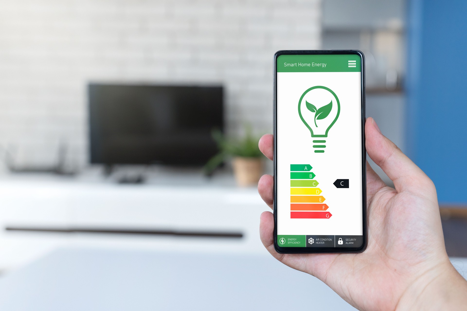 Energy efficiency mobile app on screen, eco house
